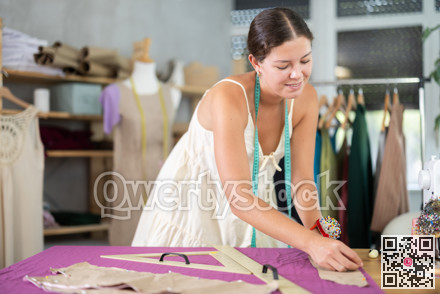 dressmaker marks and cuts the fabric