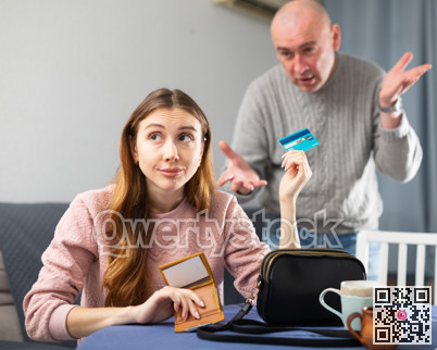 Woman giving back credit card to her husband
