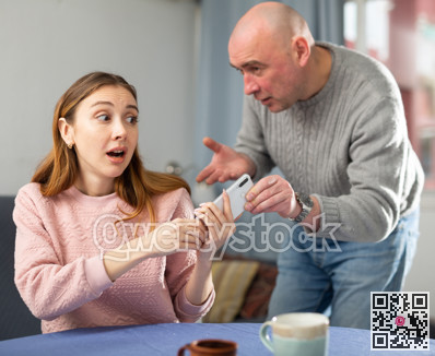 Amazed woman trying to don't give away her phone to her jealous husband