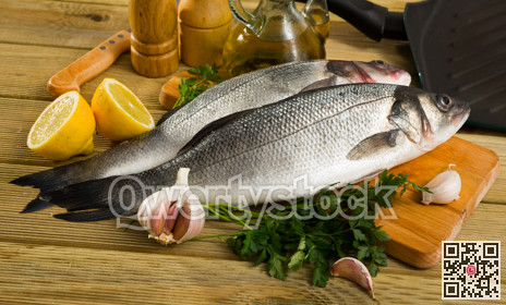 Raw sea bass on cutting board