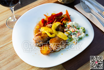 Grilled pork sirloin served with caramelized apple, stewed peppers and salad