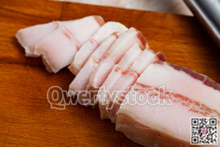 Tasty salted pork belly on wooden surface
