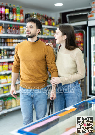 Couple of shoppers are choosing something in food store