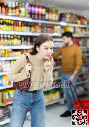 Young woman choosing food in grocery store