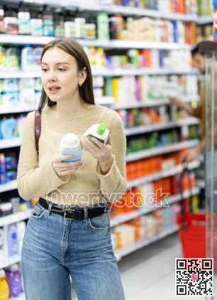 Woman spends time in store, looking for goods and select care product
