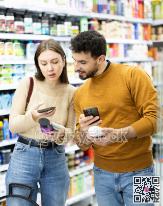 Couple get acquainted with good, scan QR code, take reading label using phone camera in shop
