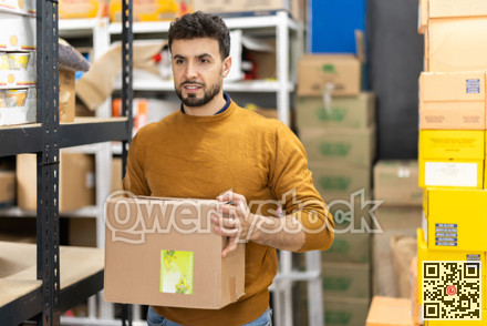 Worker loading box at warehouse store