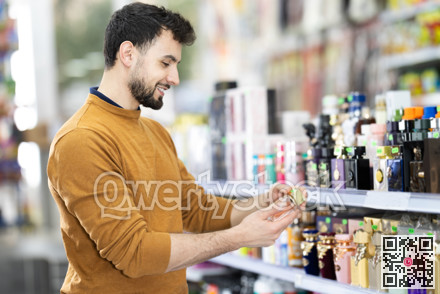 Young man chooses perfume in store