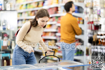 Woman spends time in store, looking for necessary goods and get out from refrigerator