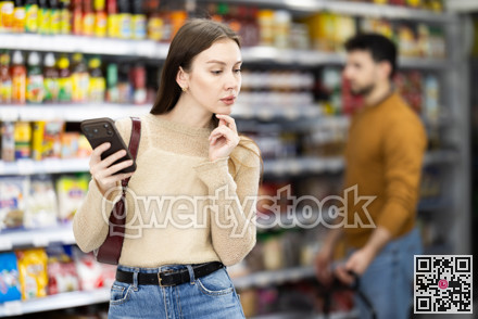 Female shopper are choosing something in food store