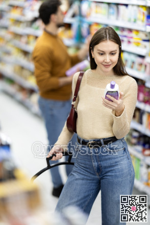 Woman spends time in store, looking for goods and select care product