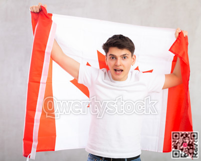 Surprised young guy holding Canada flag