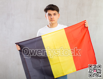 Portrait of young man of Belgium match waving national flag