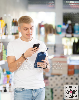 Checking expiration date of spray glass cleaner for windows - male shopper scans QR code on label of spray glass cleaner for windows using smartphone