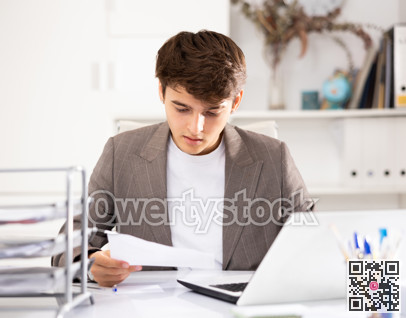 Businessman works in the office - puts documents in order and draws up contract