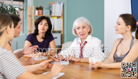 Group of women solving problems sitting around the table