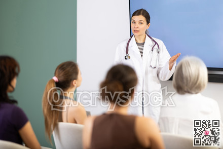 Middle-aged medical professor explaining presentation to female audience