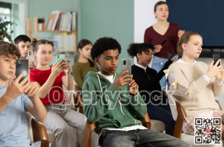 Afro American boy scans the qr code of a school lecture