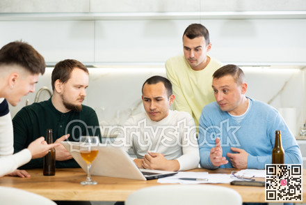 Worried male friends trying to solve problem together on laptop