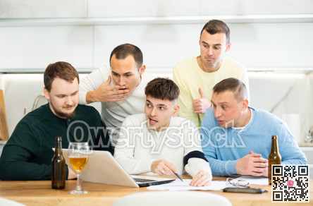 Group of football fans drinking beer and watching football match on laptop at home