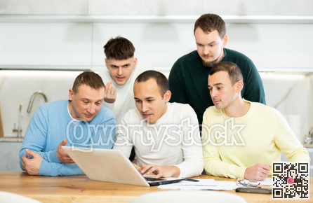 Interested men discussing content on laptop at home table