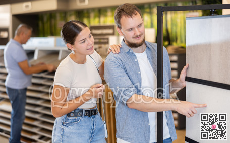 Married couple looking to buy floor tiles in materials section of hardware store