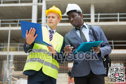 Architect and foreman must write documents and drawings on laptop with building construction