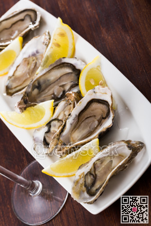 Oysters with lemon on plate