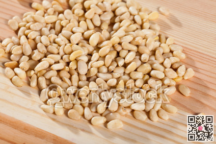Photo of mix raw pine nut on the wooden desk
