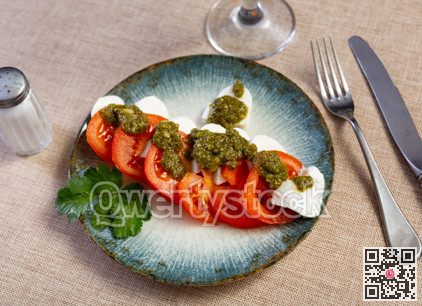Caprese salad with pesto sauce and cilantro