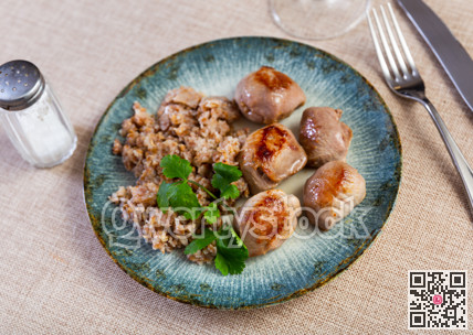 Delicious roasted turkey breast with buckwheat porridge on table