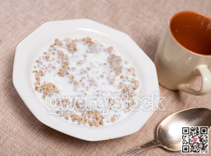 Buckwheat porridge with milk in bowl closeup