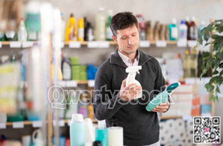 Middle-aged man choosing cleaning spray at department store