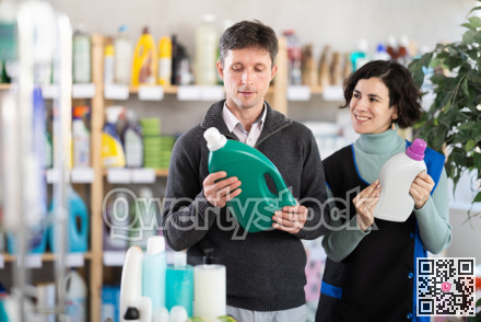Female saleswoman offers man buy a detergent in supermarket