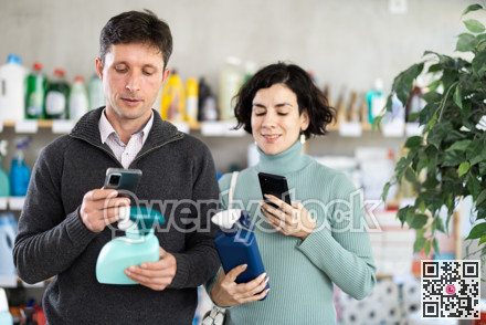 Couple man and woman scanning qr code for cleaning spray