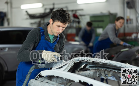 Man auto mechanic polishes body parts by car buffer polisher machine tool