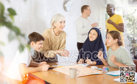 Smiling elderly woman playing board game with friends
