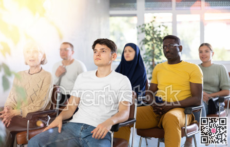Guy teenager listens to lecture while sitting on chair