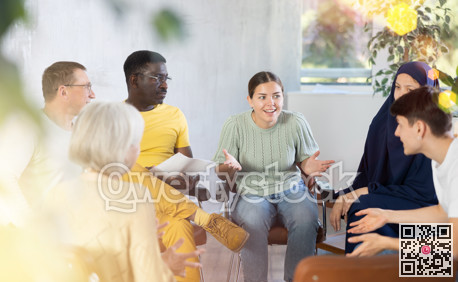 Woman tells an interesting story. Multinational students listening carefully in classroom