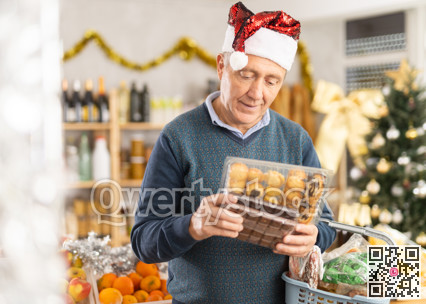 Portrait of mature man buying chocolate and chocolate candies for gift and celebrating Christmas