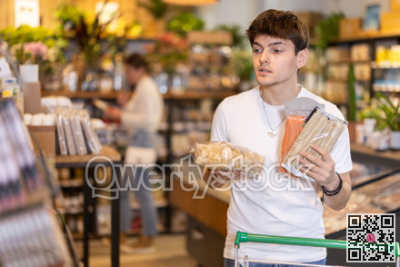 Store visitor, guy in sales area choosing pasta