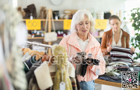 Elderly woman choosing gloves in clothing store
