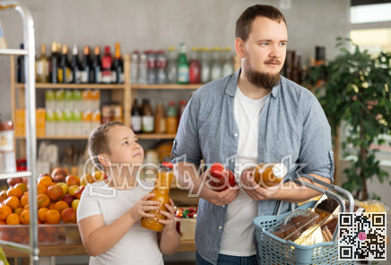 Man with son hold packages plastic bottle and choose consider fruit juice in store
