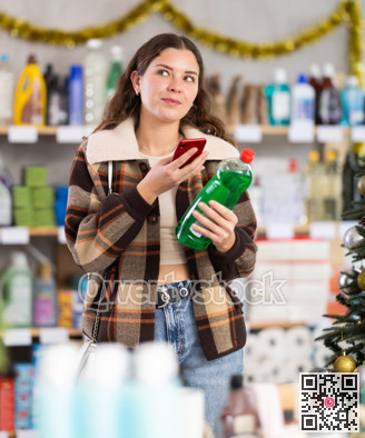 Young woman scanning qr code for dishwashing