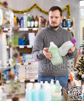 Man chooses detergent in supermarket before Christmas