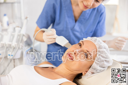 Young woman undergoing facial cleansing procedure using ultrasonic shovel