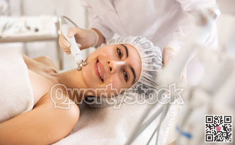 Female client getting face skin rf lifting procedure in cosmetic clinic