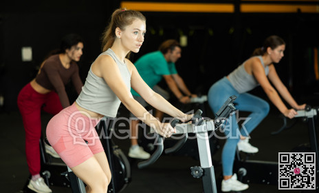 Athletic woman doing exercises on exercise bike