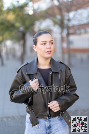 Young female tourist walks through a spring city and takes in sights
