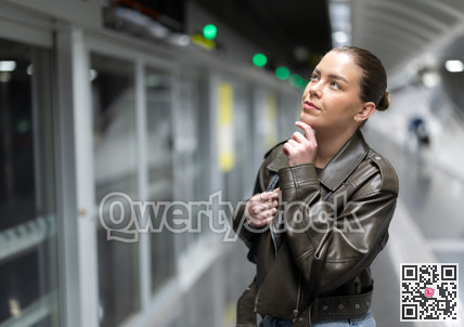 Pretty girl walks along the platform waiting for subway train